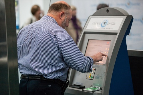 an arriving passenger using Global Entry kiosk at Newark International Airport