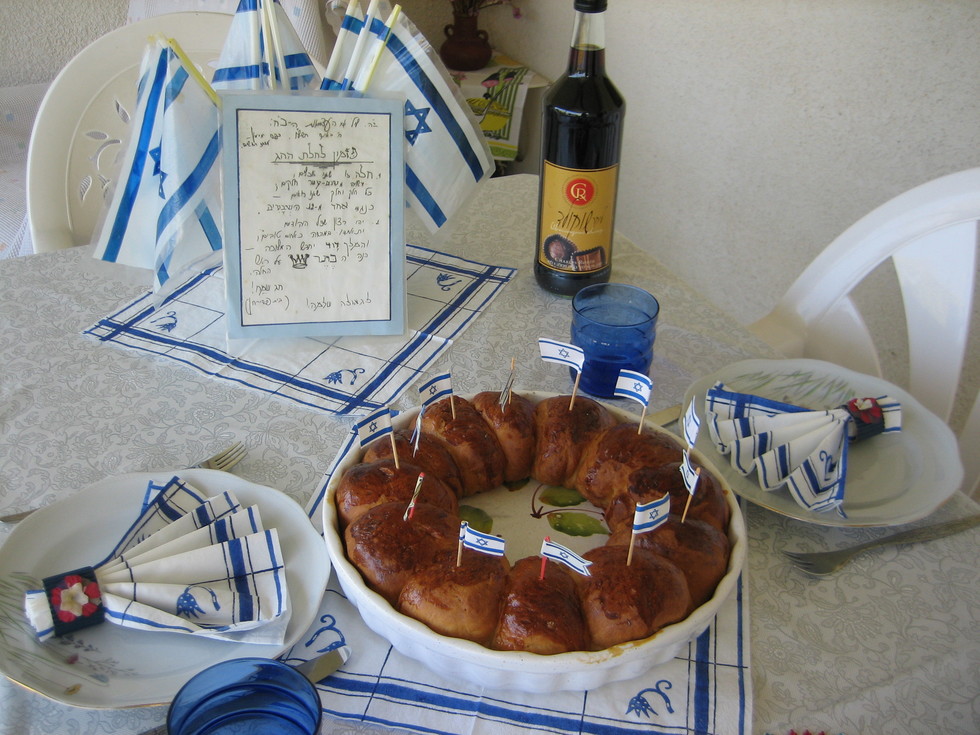 An Israeli holiday table, complete with twelve tribes challah