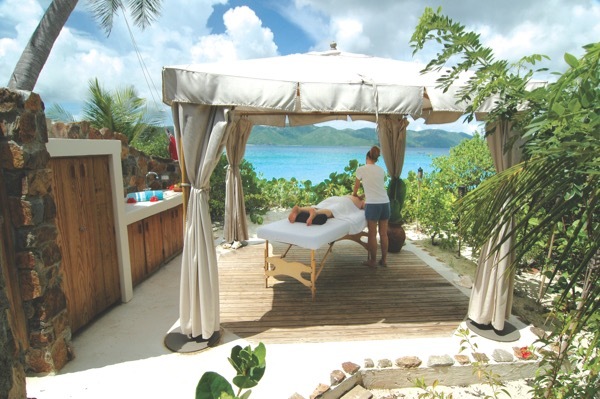 A man gets an outdoor massage on Guana Island