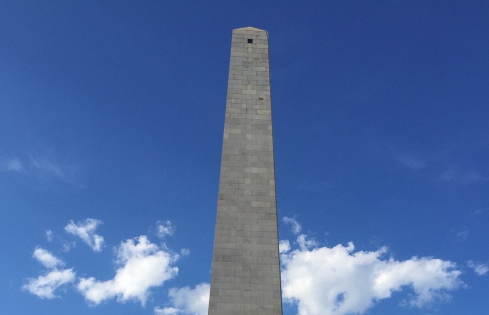 A 221-foot granite obelisk. Only the sky and a few clouds are visible around it.