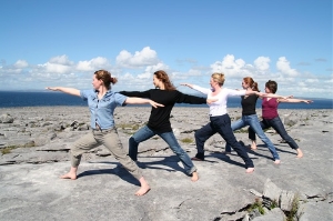 Yoga poses on the limestone rocks overlooking the Atlantic Ocean, at Burren Yoga and Meditation Centre