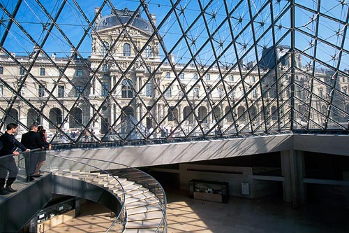 Inside looking out of the glass pyramid that stands in the courtyard of Le Louvre Museum and provides the entrance to the three main underground areas.