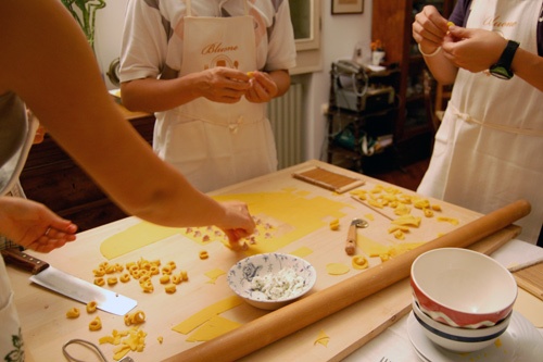 During a class at Bluone Cooking Tours in Italy, students learn to make tortellini from scratch. Photo: Bluone Photo