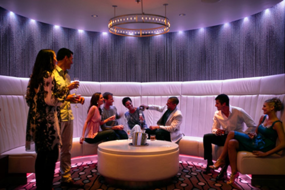 Group of friends having drinks at Quasar nightclub onboard Celebrity Solstice.