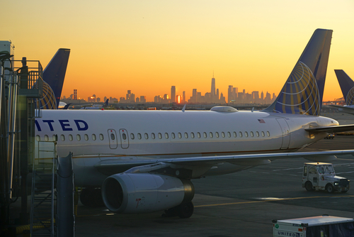 United Airlines at Newark Airport gate at sunrise, Mahattan skyline in background