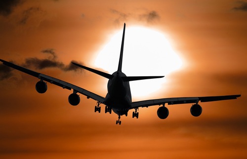 Airplane flies into sunset