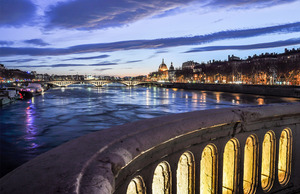 The lights of the city reflected along Rhône river at sunset in Lyon