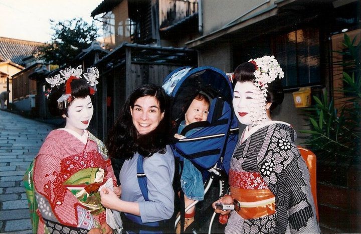 The author and her infant daughter pose with apprentice geishas, in full costume, on the streets of Kyoto