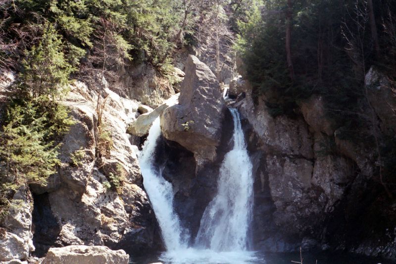 A small waterfall flows over rocks. 