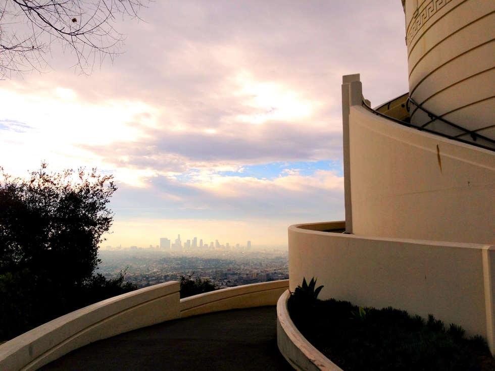 The sun sets on downtown Los Angeles and the Griffith Observatory