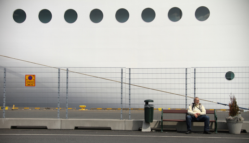 man sitting outside a cruise ship