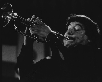 A trumpeteer plays jazz music.