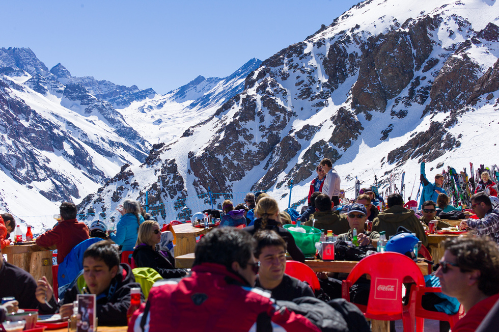 Skiiers and snowboarders taking a break to eat at a restaurant in the Andes