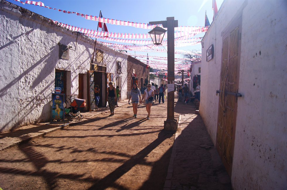 Tourists walking through the adobe town of San Pedro de Atacama