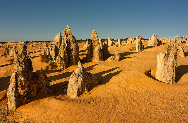 A view of the pinnacles rising from the desert during sunset