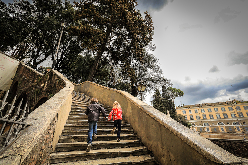 Boy and girl running up stairs in Pincio gardens