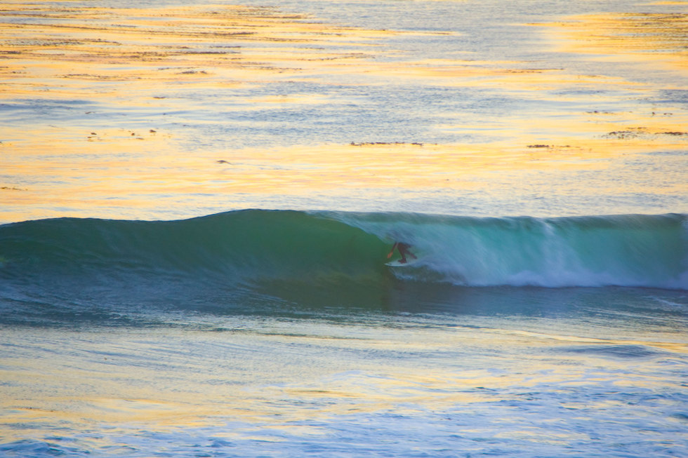A photo of a man riding a wave in Santa Cruz