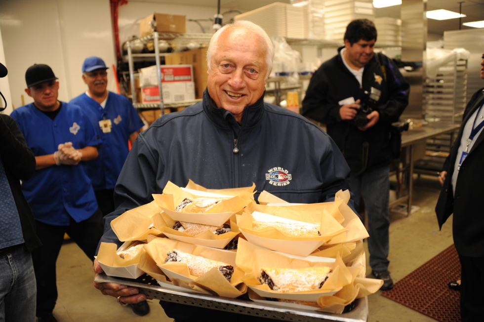 LA Dodgers former manager Tommy Lasorda holding a tray of cannoli