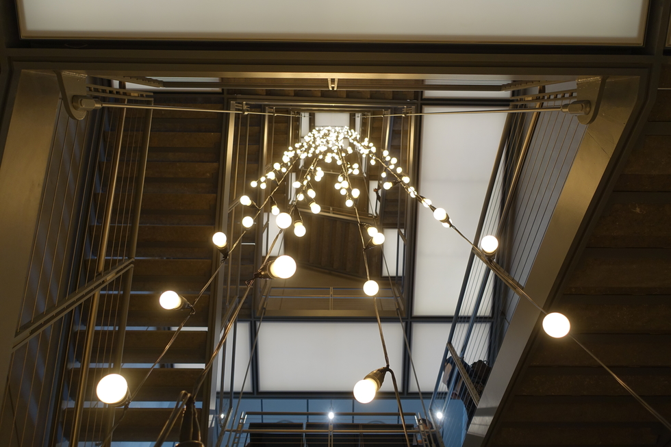 A massive light sculpture hangs in the stairwell at the Whitney Museum