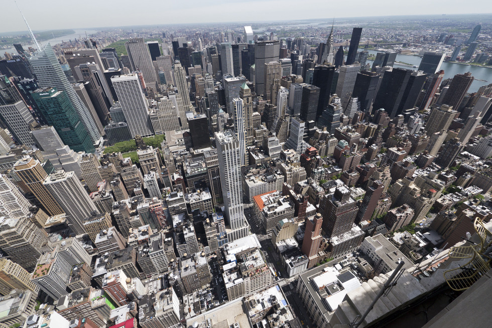 An aerial view of Manhattan, with the Empire State Building in the background. 