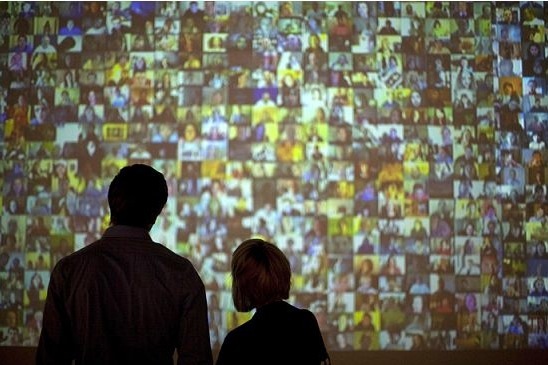Guests look at a video installation at the Plains Art Museum in Fargo, North Dakota