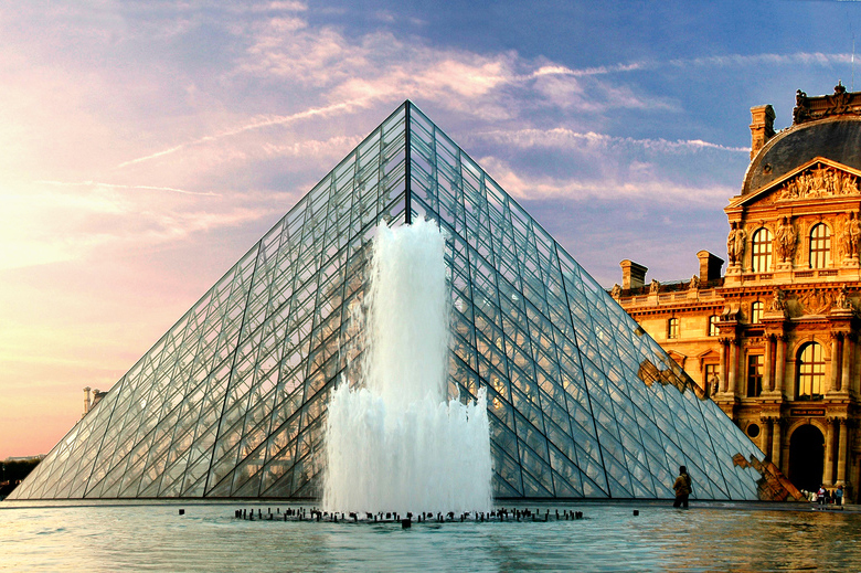 The Louvre behind a fountain in Paris, France. 