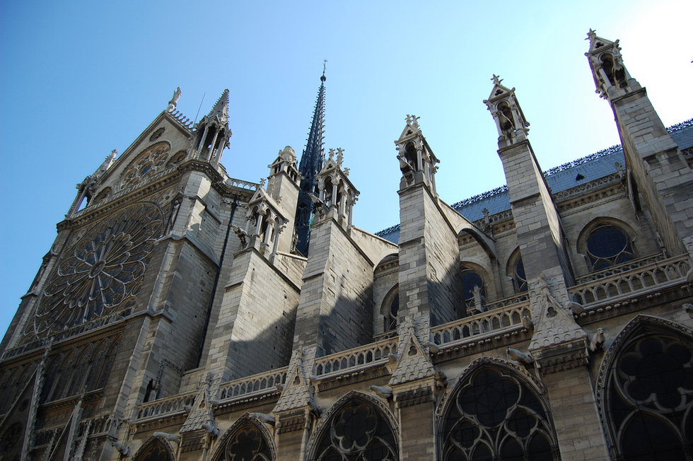 Cathédrale Notre-Dame de Paris against a blue sky in Normandy, France.