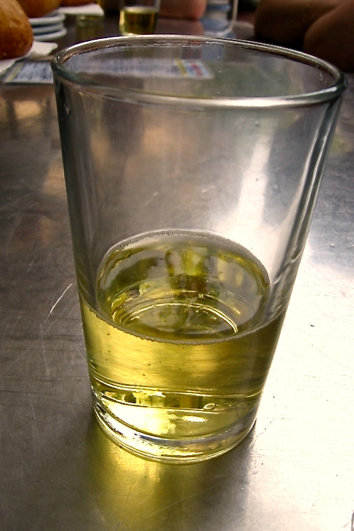 A half-empty glass of crisp Asturian cider