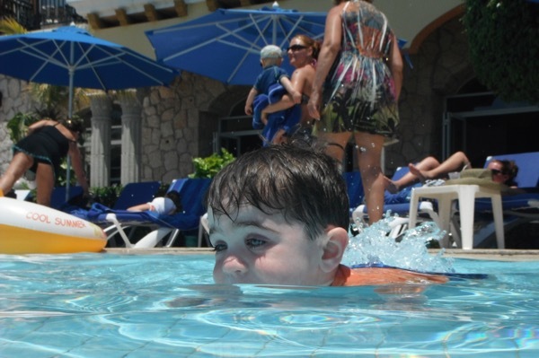 A young boy swims in the kiddie pool in Playa del Carmen.