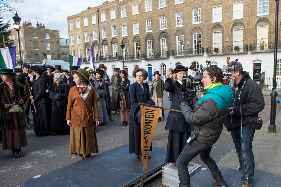 Anne-Marie Duff (center, left) and Carey Mulligan (center, right) filming an exterior Parliament scene on the set of director Sarah Gavron’s SUFFRAGETTE, a Focus Features release. 