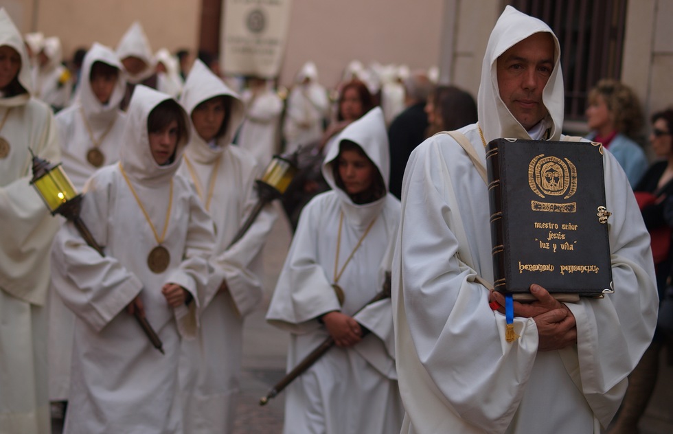 White robed congregation members get ready to take part in a Holy Week procession in Zamora, Spain.