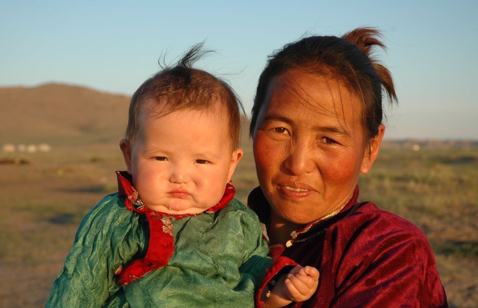A Mongolian woman and her baby on the steppes of Mongolia