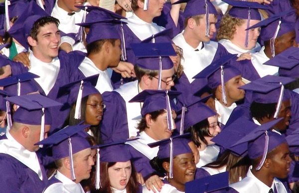 A close-up of students about to graduate from college.