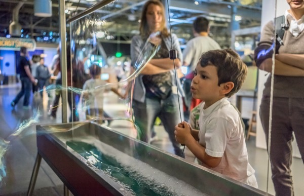A young boy blows a massive bubble at the Explorotorium