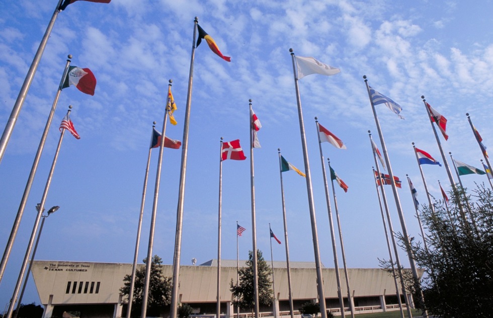 Flags flutter outside the Institute of Texan Cultures