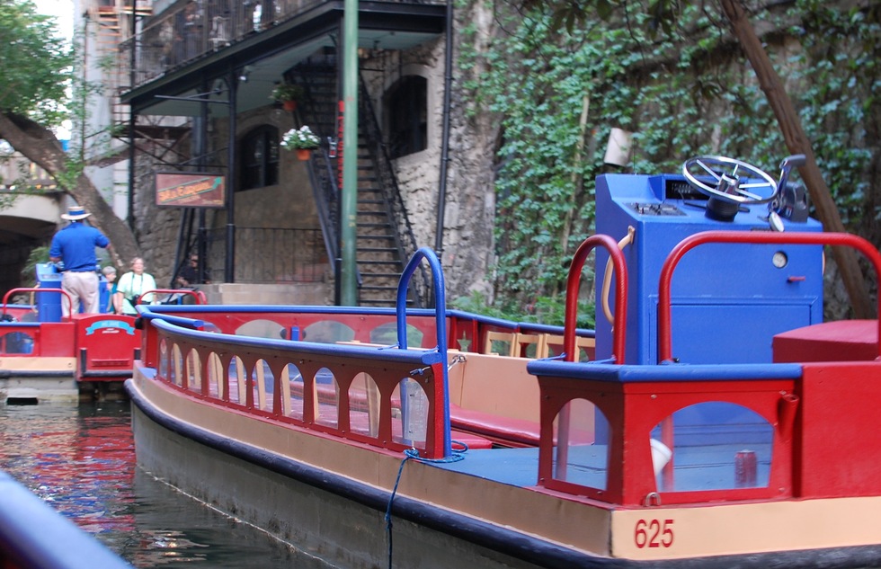 A tour boat waits for passengers to go cruising down the San Antonio River