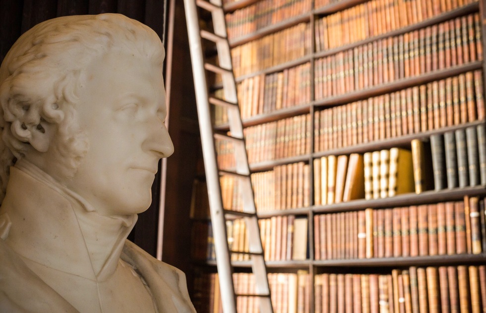 A marble bust and shelves of books inside the Old Library at Trinity College in Dublin