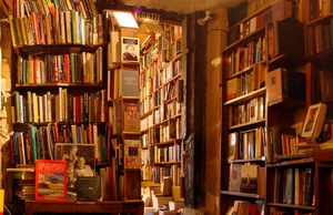 Books reach to the rafters on rickety shelves inside Shakespeare and Company, an acclaimed English-language bookstore in Paris 