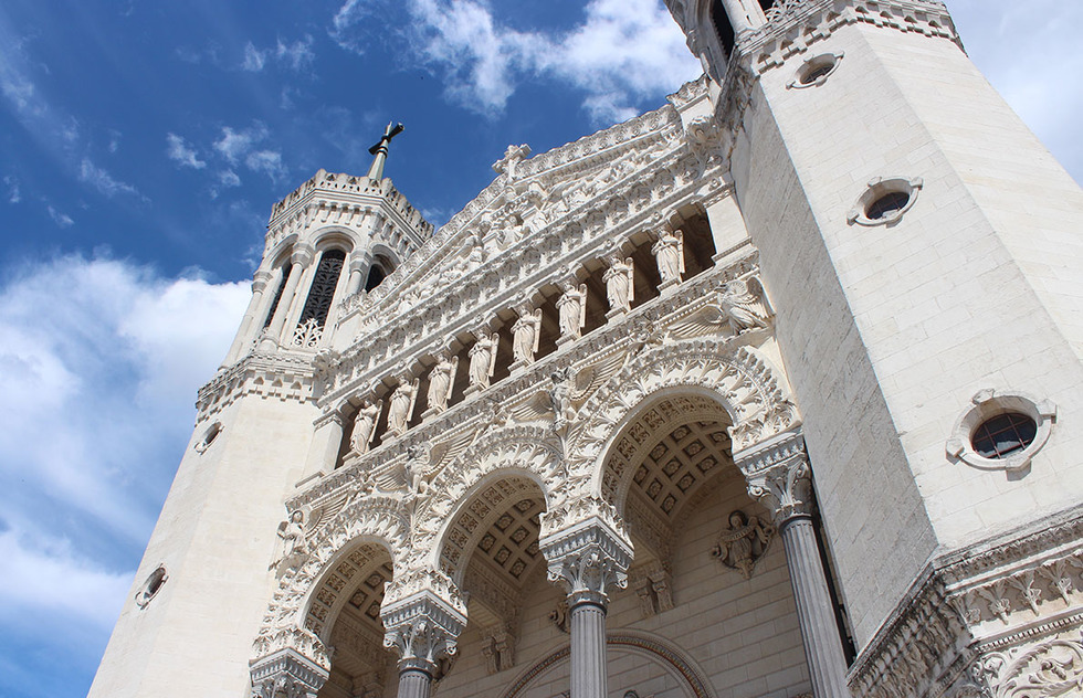 A photo of Basilica of Notre-Dame de Fourvière's relatively austere neo-Byzantine façade, which contrasts with its ornately decorated interior