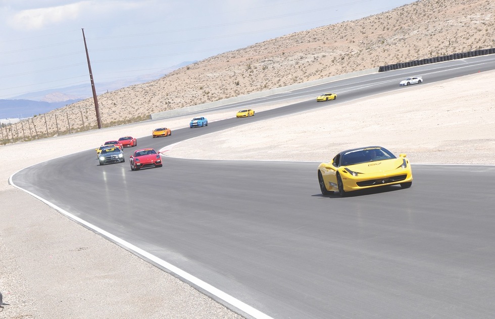 Cars zoom around the track at SpeedVegas