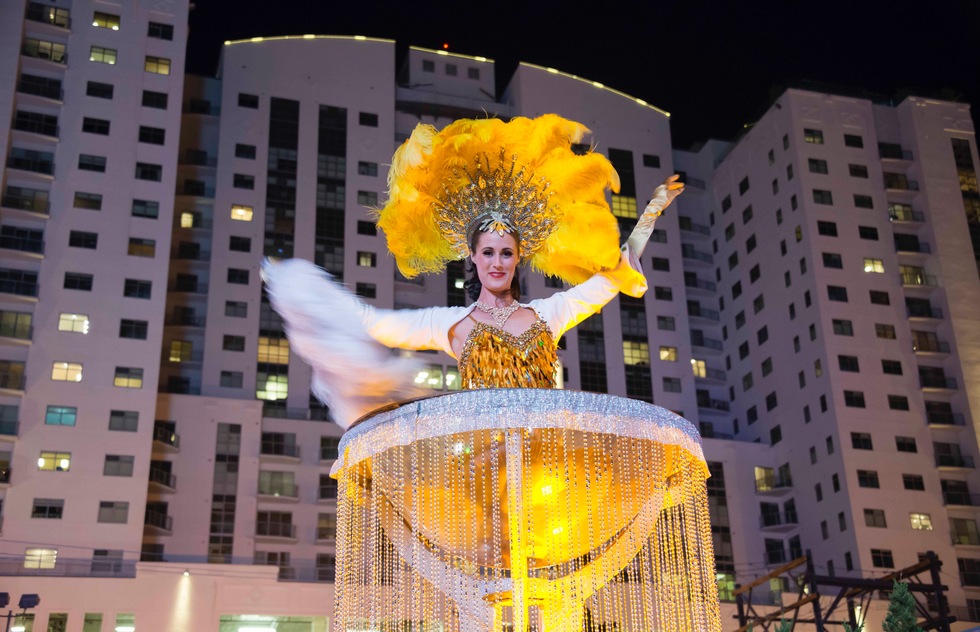 A showgirl pops out of a massive champagne flute in Las Vegas