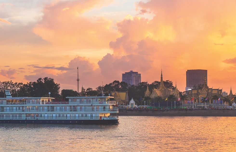 A river cruise ship navigates the Mekong River, which passes through Vietnam and Cambodia