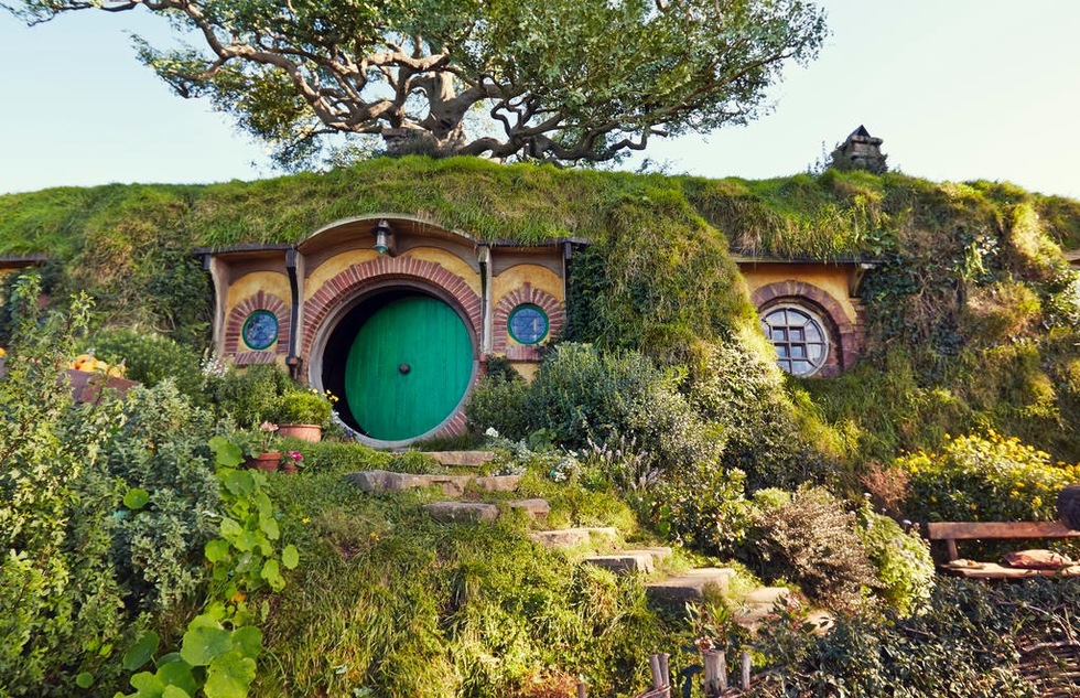 Exterior of a "Hobbit hole" built into a hillside at the Hobbiton Movie Set in New Zealand