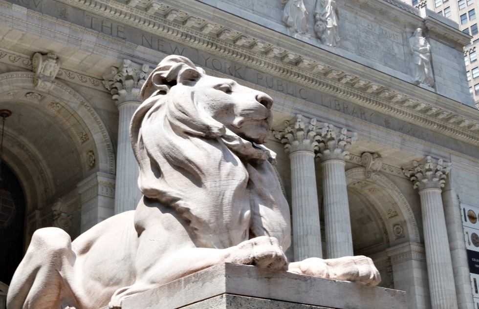 A stone lion guards the entrance to the New York Public Library.