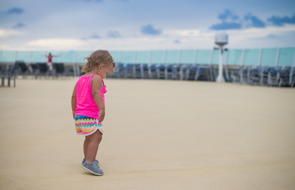 A baby on the deck of a Royal Caribbean ship