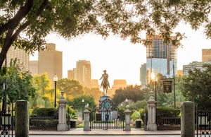 A statue of George Washington on horseback in the center of a public garden in Boston. 