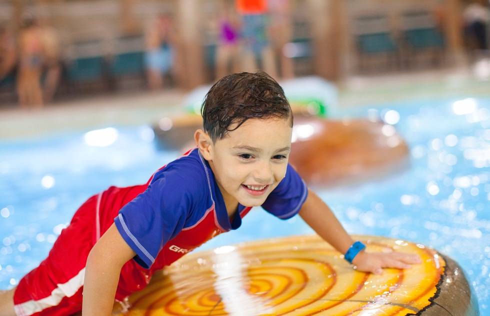 A kid at one of Great Wolf Lodge's indoor water park