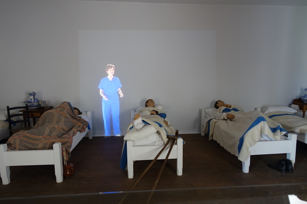A 3-D projection of a woman discusses  