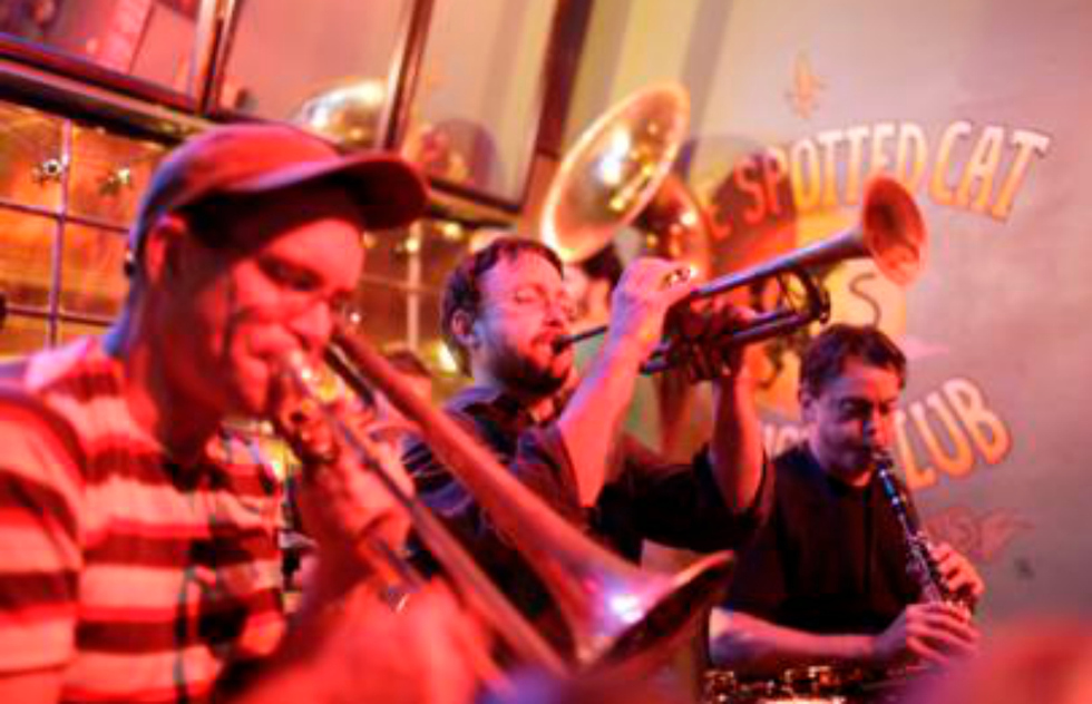 A row of musicians blast various horns at the Spotted Cat Music Club. 