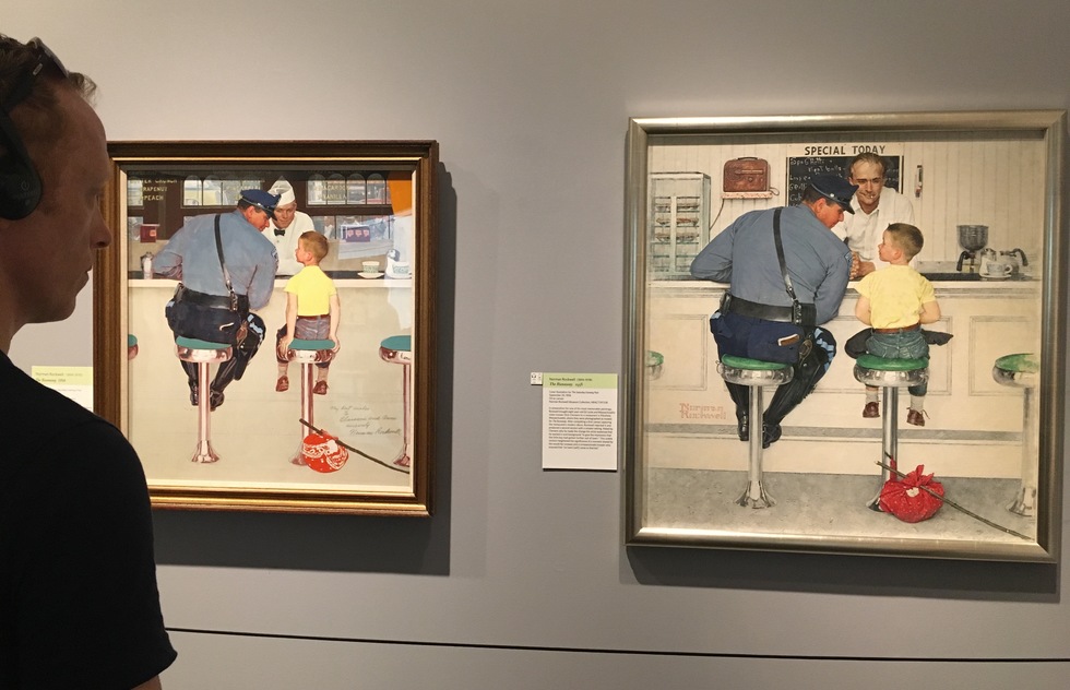 A viewer looks at two version of Rockwell's iconic painting of a policeman and a young runaway